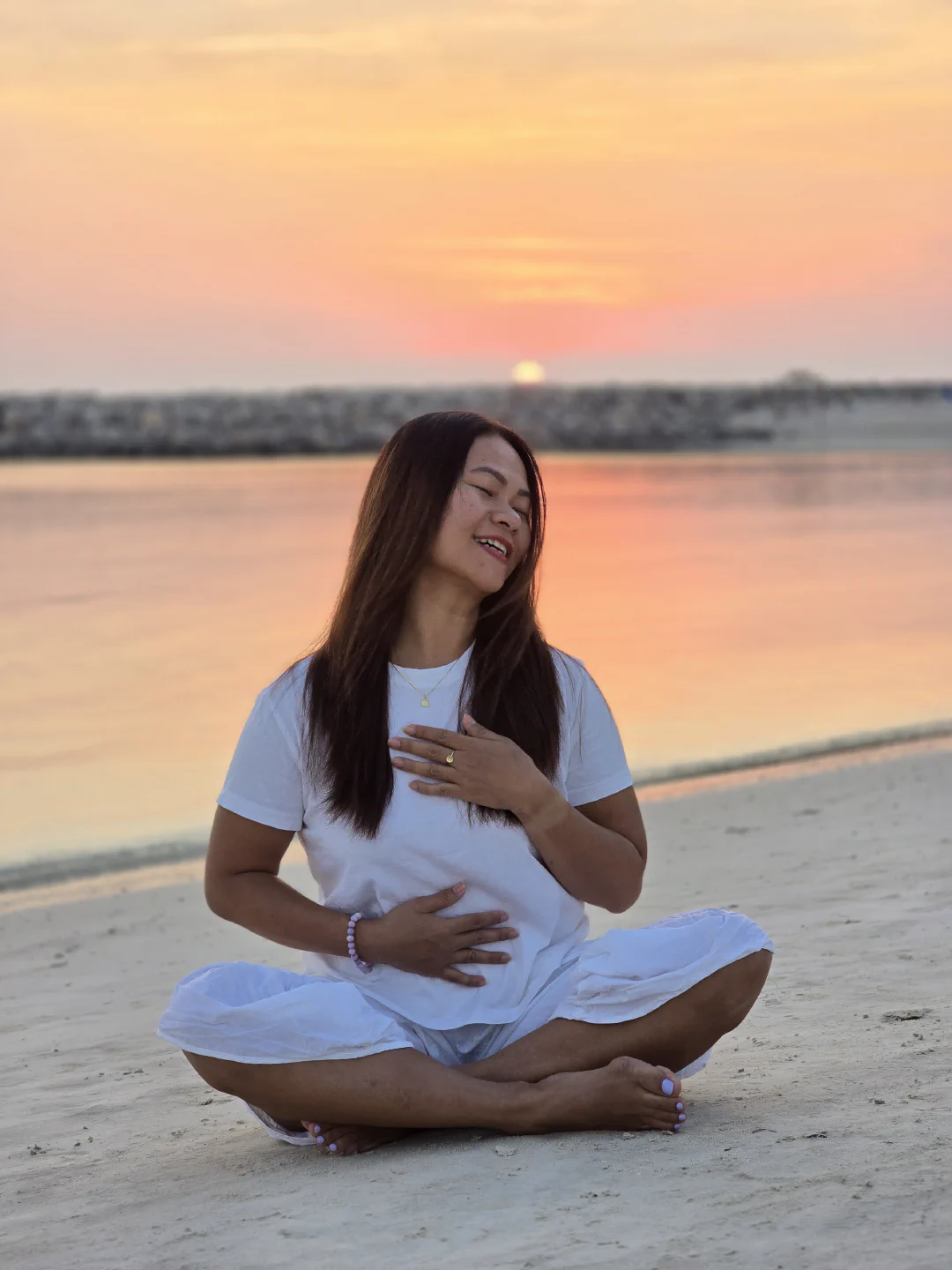 Kim Hangzo at sunset, hand on heart